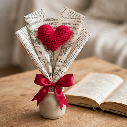 Single Heart-Shaped Flower with Newspaper Wrapping and Red Ribbon Bow
