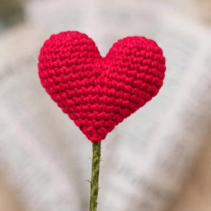 Single Heart-Shaped Flower with Newspaper Wrapping and Red Ribbon Bow